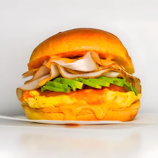 A Gyro 101 breakfast sandwich with turkey, avocado, egg, and cheese on a brioche bun.